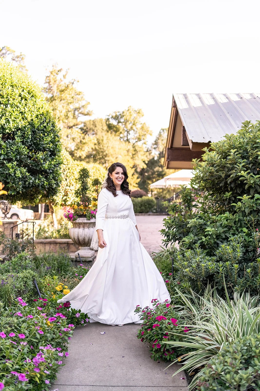 Bride in the gardens at Madera Estates wedding venue in Conroe, TX