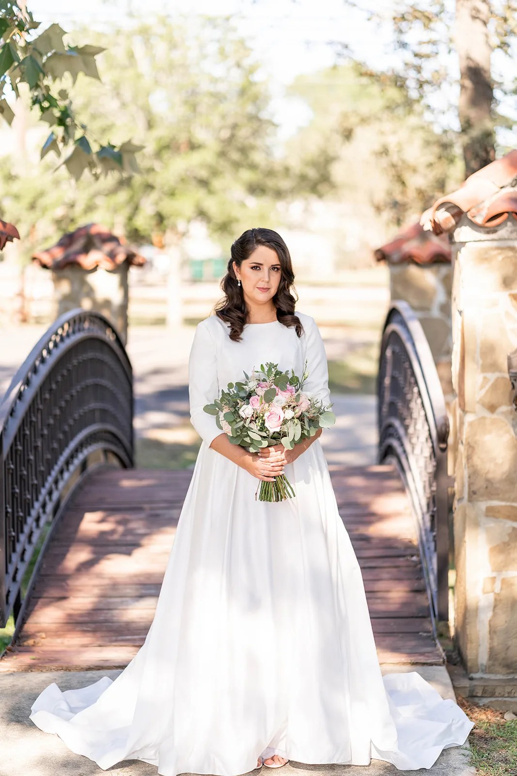 Bride by the arched windows at Madera Estates in Conroe, TX