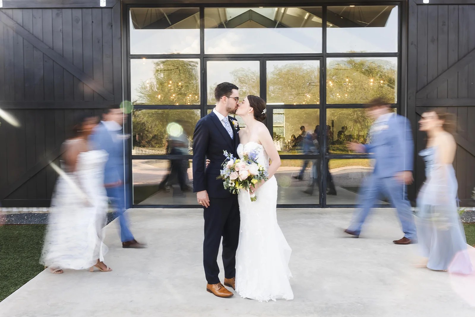 Bride and groom at the glass entry at Mae's Ridge at Mae's Ridge, Johnson City, TX