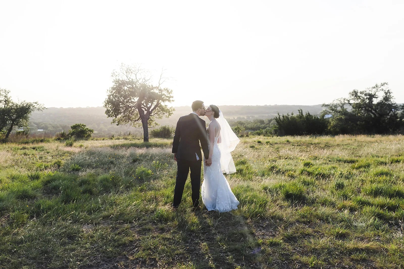 Bride and groom in the field at Mae's Ridge Johnson City at Mae's Ridge, Johnson City, TX