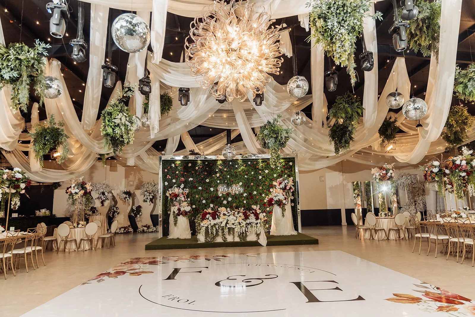 Head table under the ballroom chandelier at Monarca Event Center in Edinburg