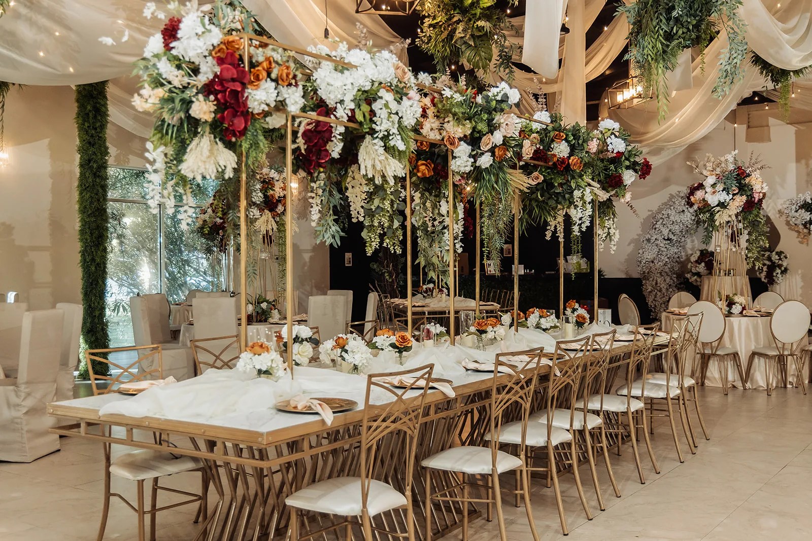 Long banquet table with tall floral centerpieces at Monarca Event Center Edinburg