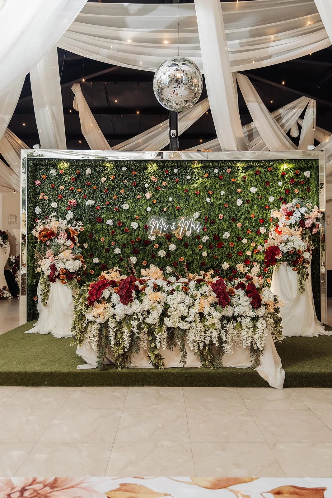 Greenery and floral wall backdrop at Monarca Event Center in Edinburg, Texas