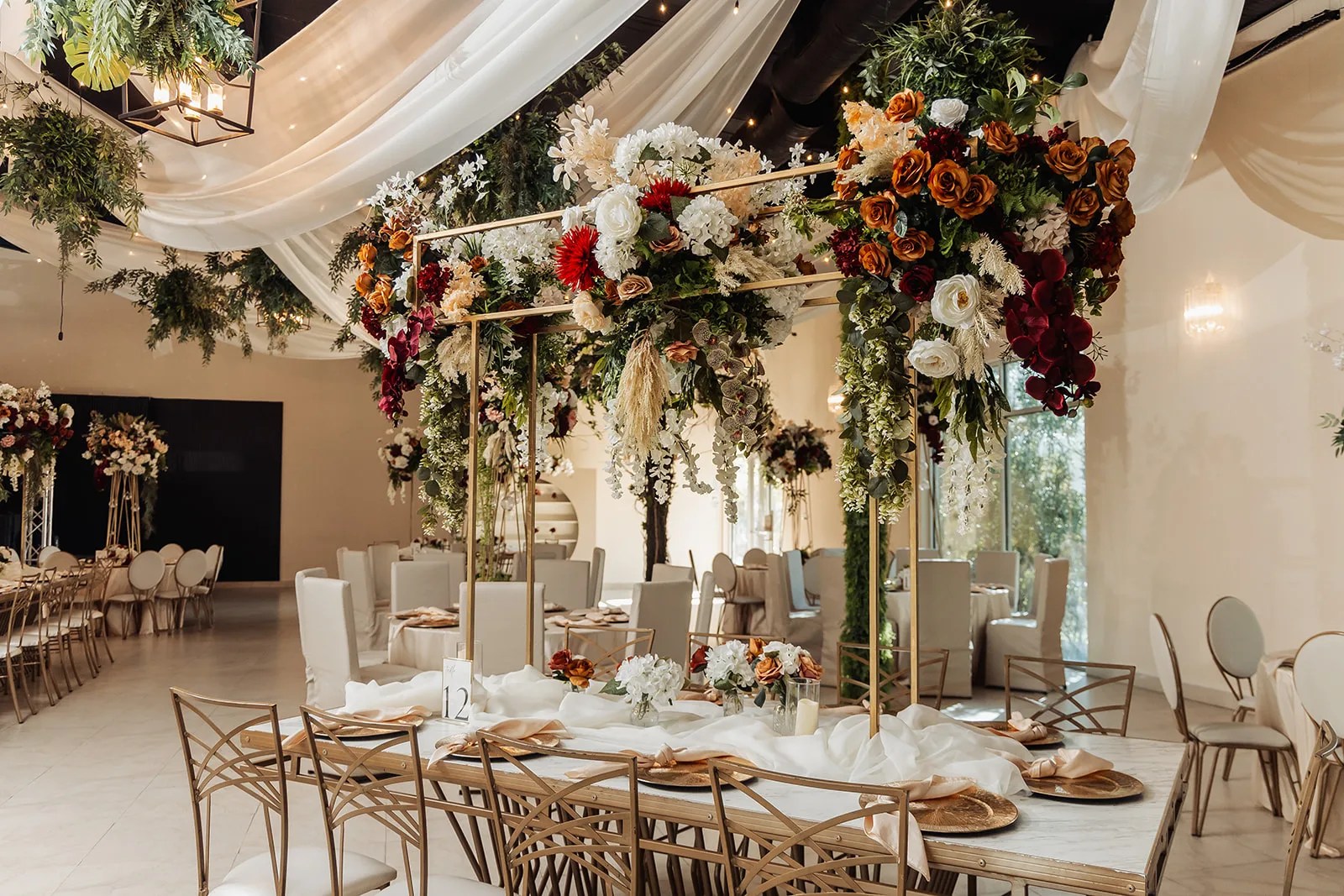Tall floral centerpiece on a reception table at Monarca Event Center Edinburg