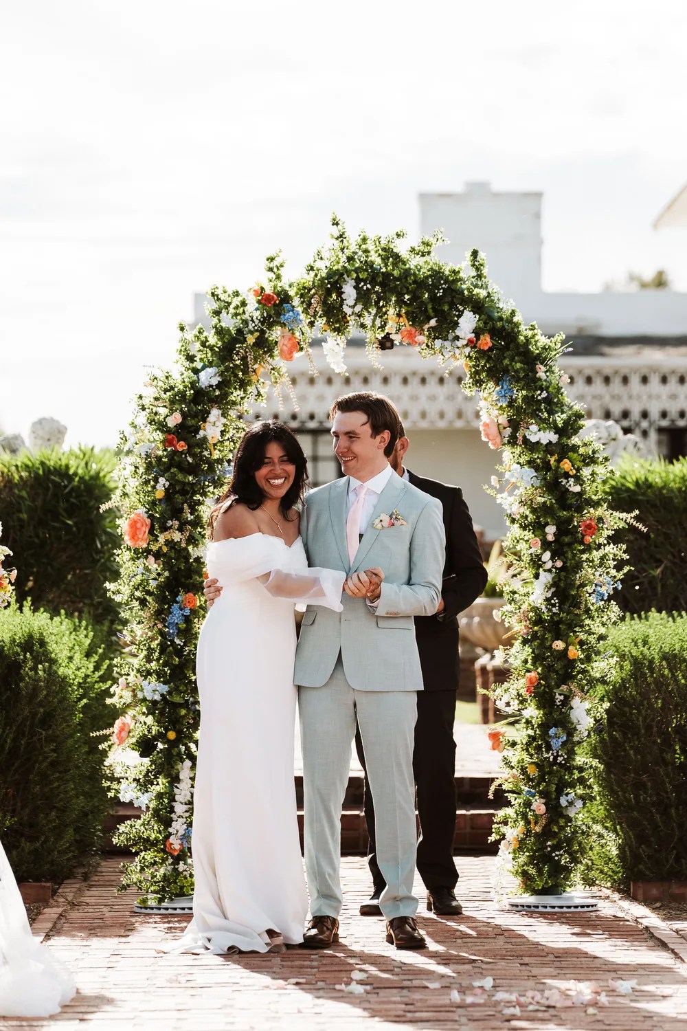 Vows at the floral arch at Nardini Manor