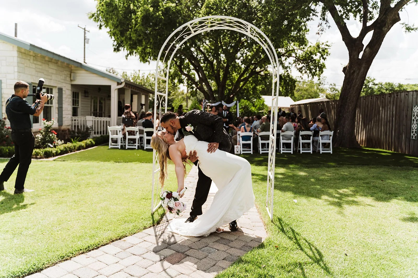 Couple at the ceremony arbor at Owen House, Round Rock, TX