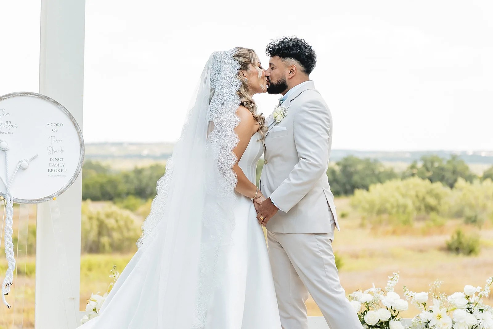 Bride and groom with the Hill Country behind them at Prospect House at Prospect House, Dripping Springs, TX