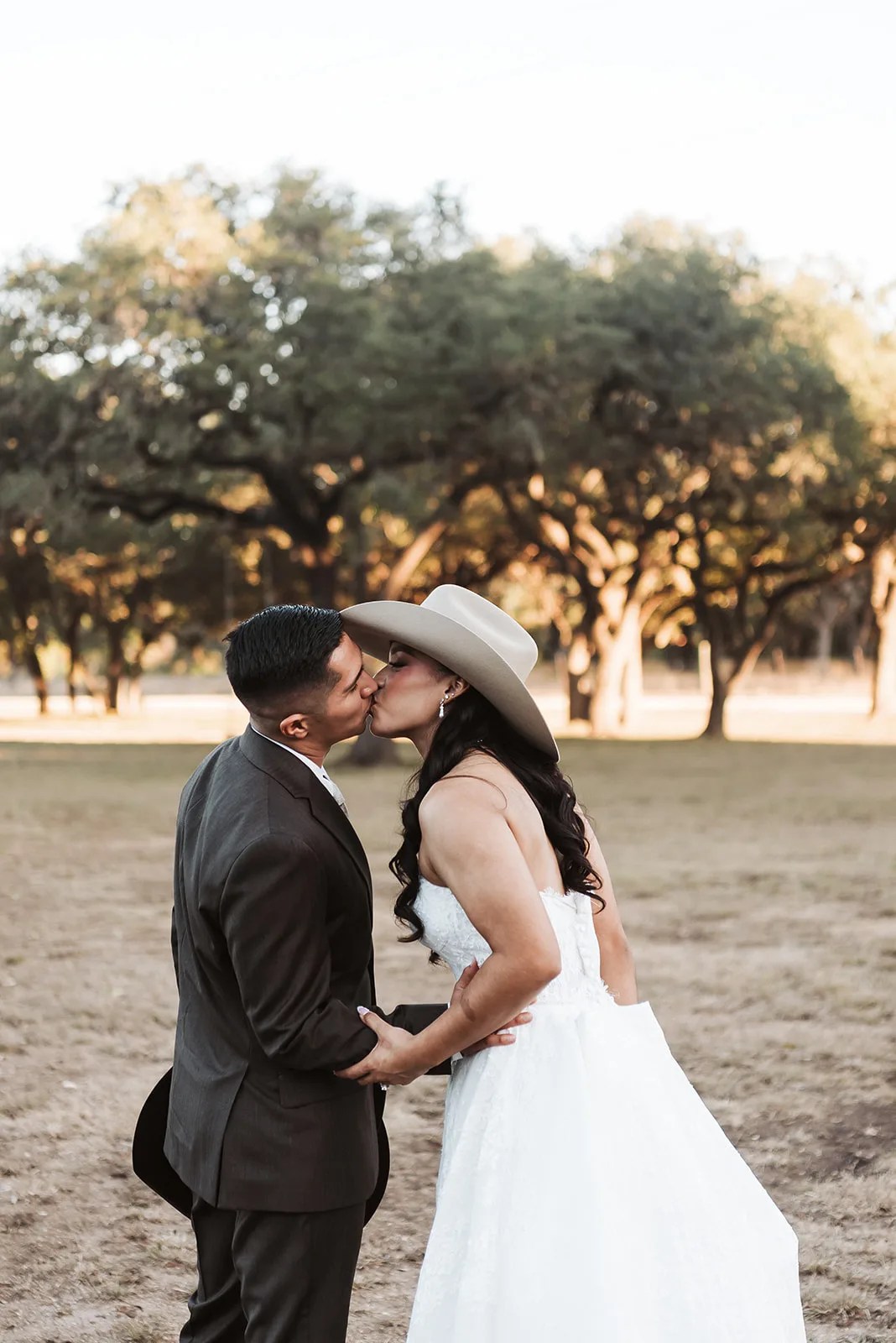 Bride and groom under the oaks at Rockin B Ranch at Rockin' B Ranch, Pipe Creek, TX