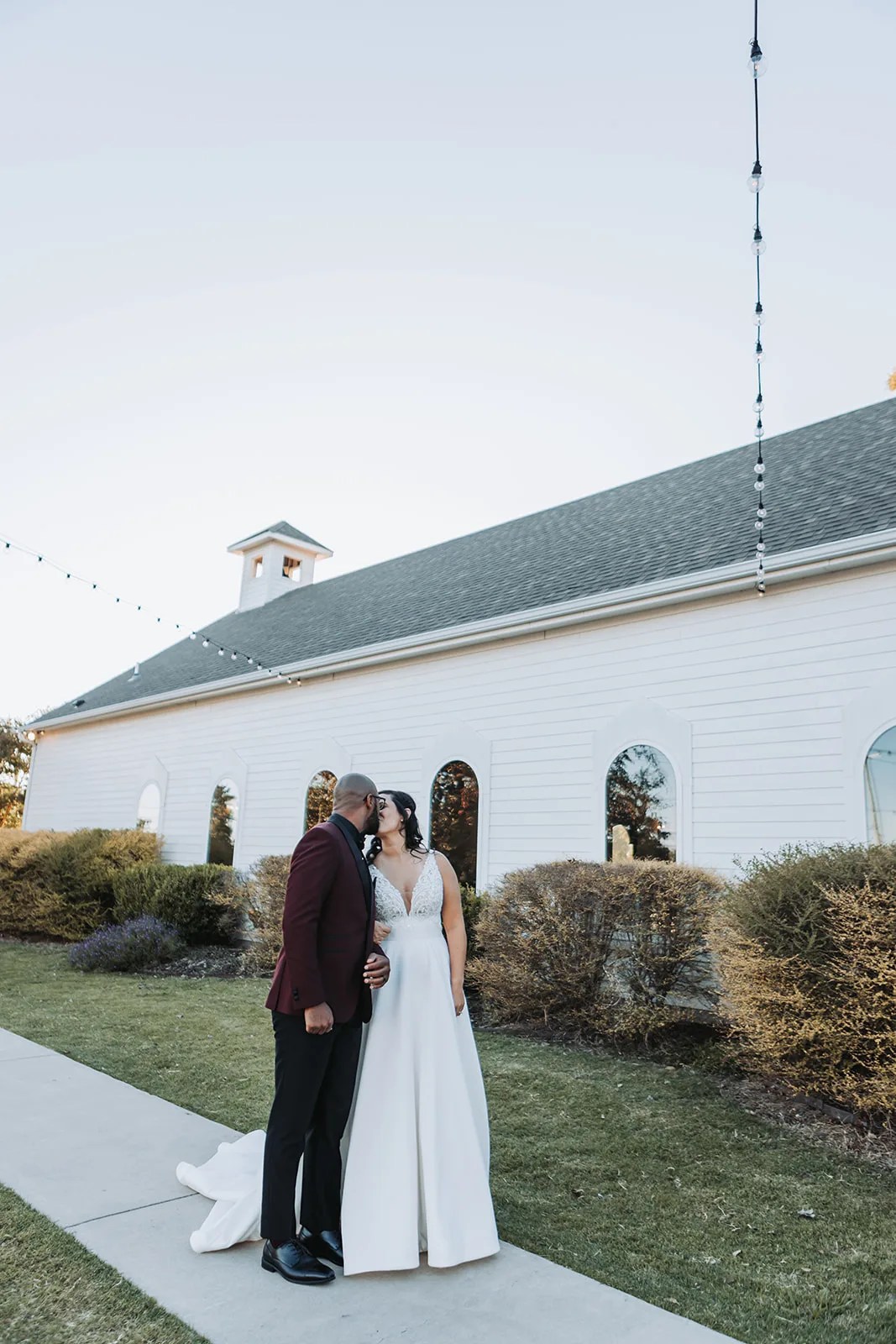 Bride and groom outside the chapel at Rustic Grace Estate at Rustic Grace Estate, Van Alstyne, TX