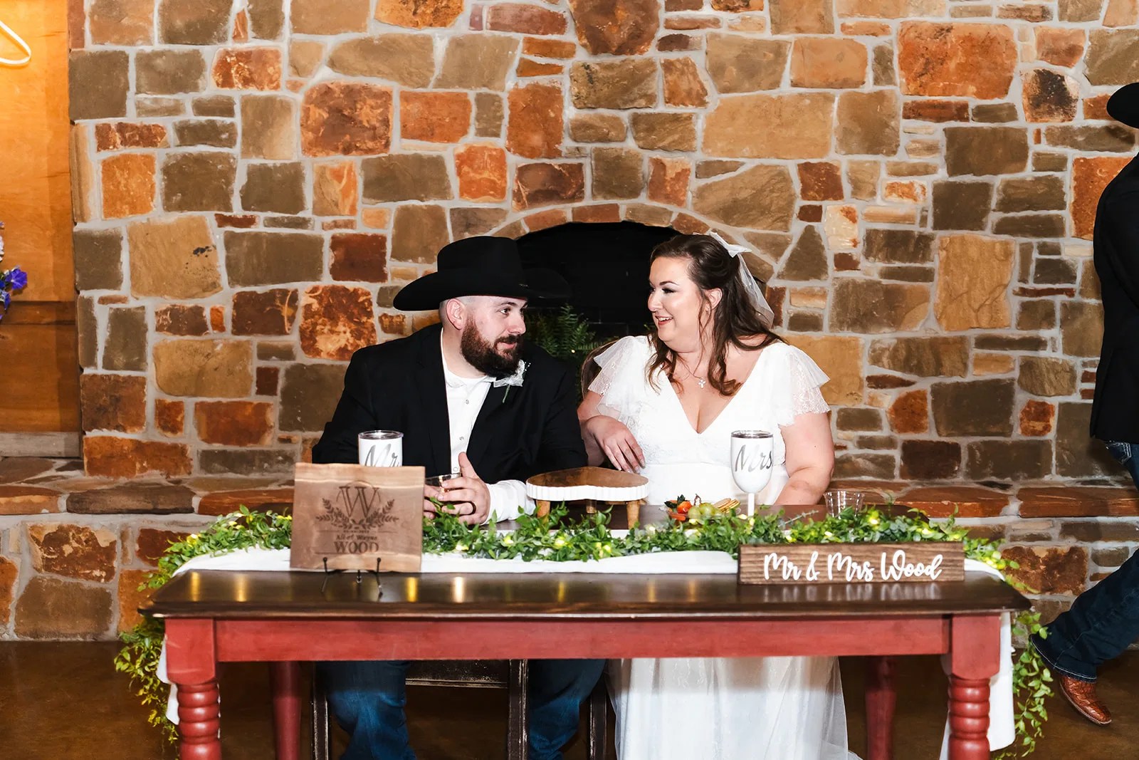 Head table in the reception barn at Rustic Rose Events in Willis, TX
