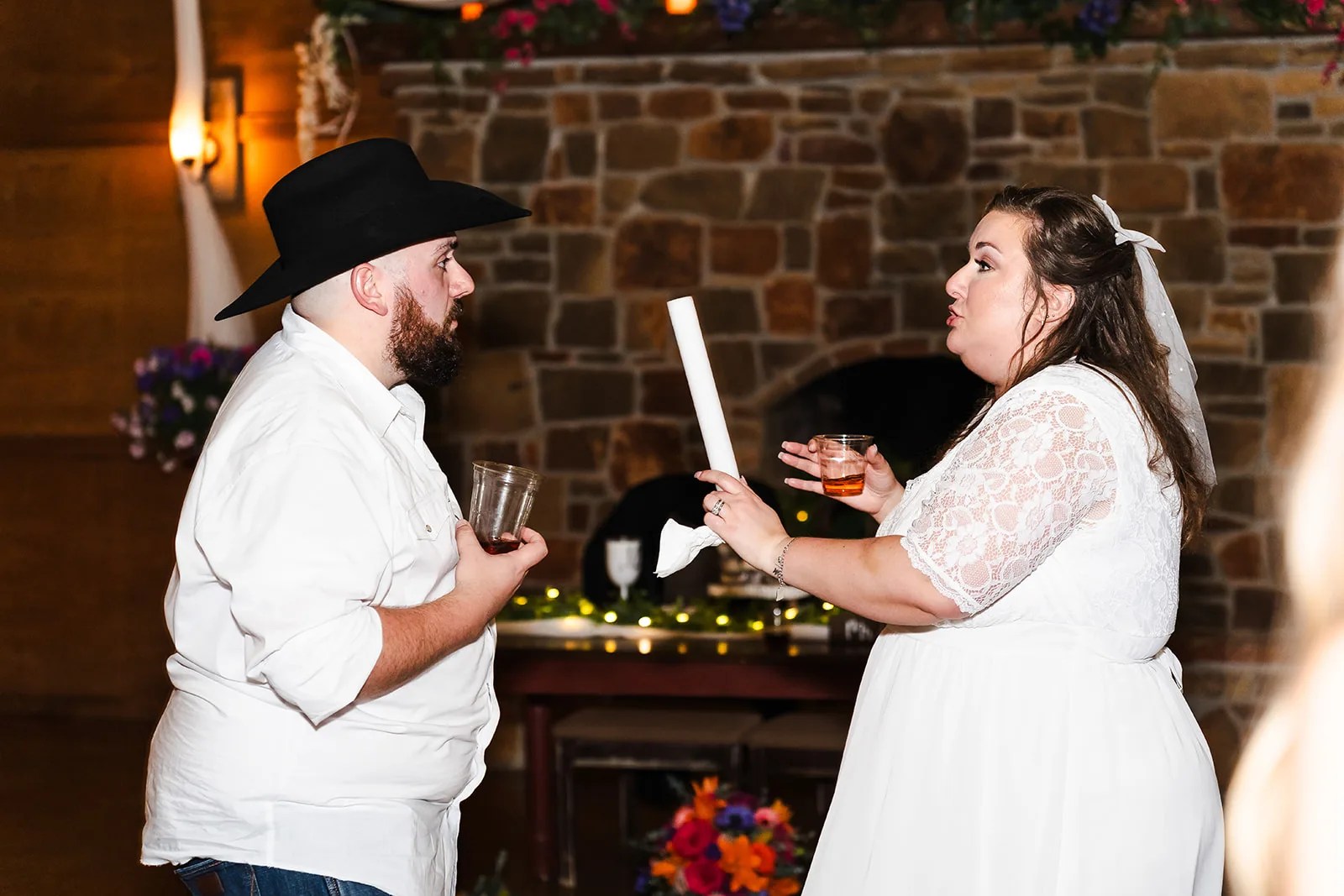Bride and groom at the rock wall at night at Rustic Rose Events in Willis, TX