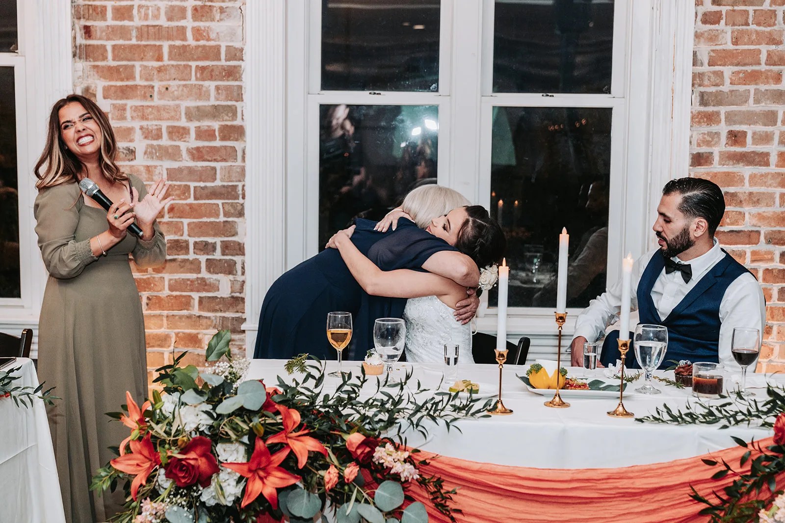 Guests at reception tables by the tall windows at Station 3 in Houston, TX