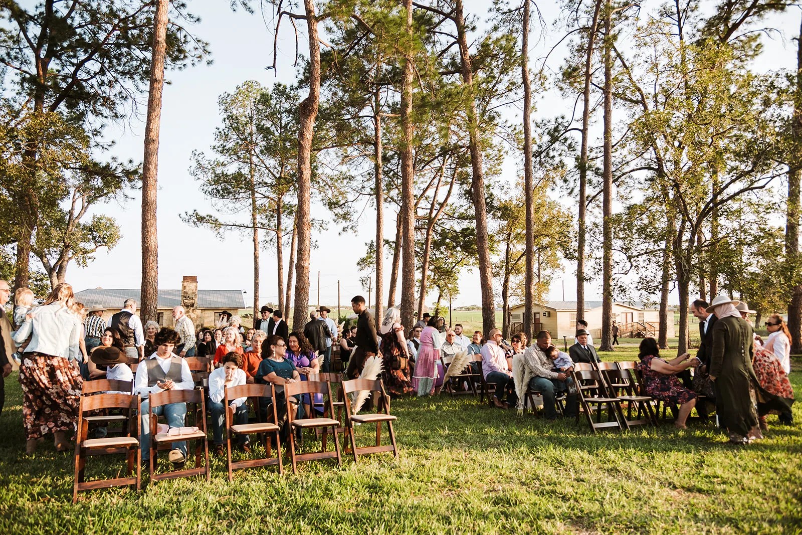 Wedding ceremony under the pines at Strawberry Pines in Poteet, Texas at Strawberry Pines, Poteet, TX