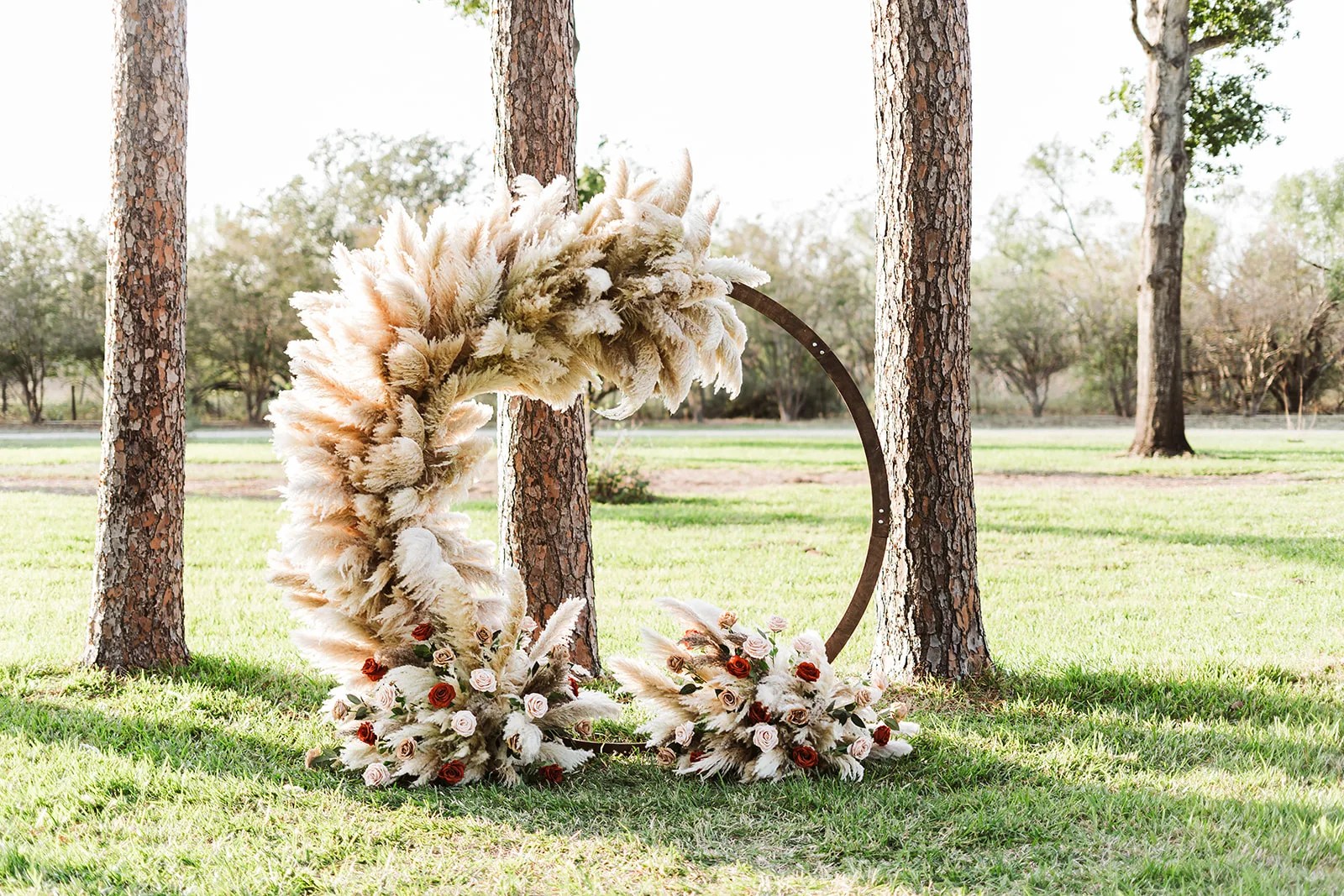 Pampas ceremony arch on the lawn at Strawberry Pines at Strawberry Pines, Poteet, TX