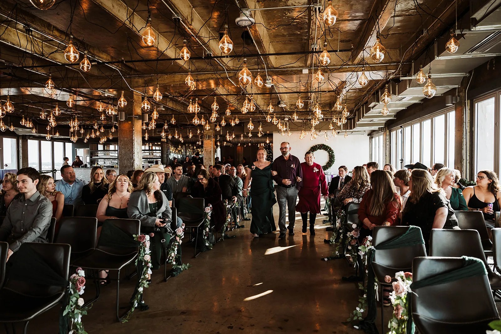 Wedding ceremony under the glass pendants at Sunago Bell at Sunago Bell, Denton, TX