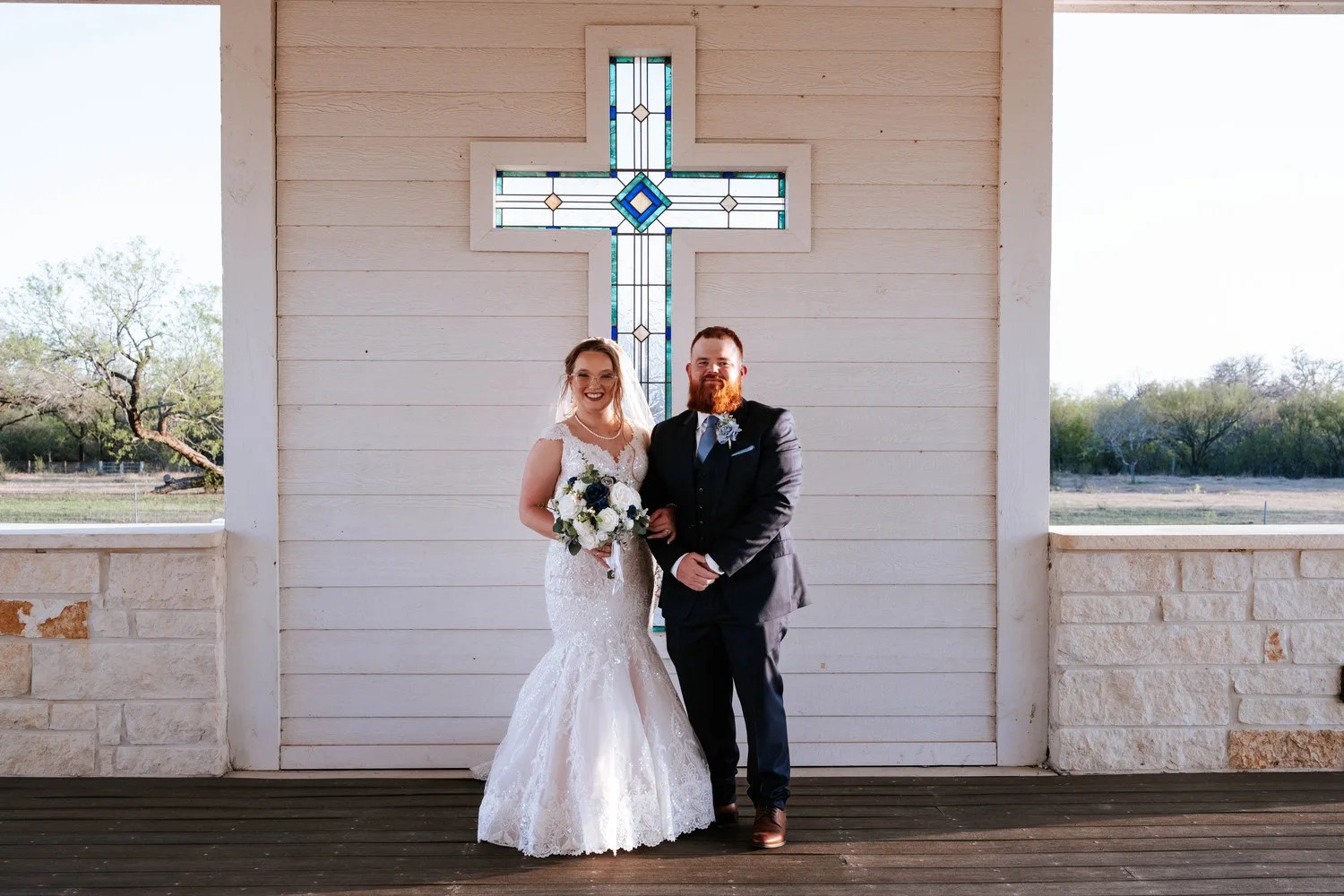 Bride and groom at the chapel cross at Teaghlach Meadows Yorktown