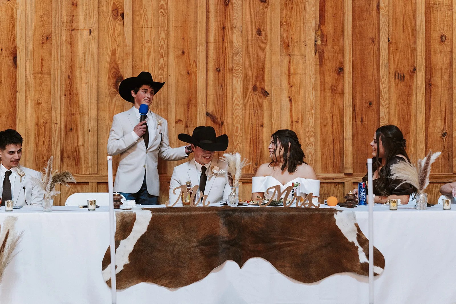 Head table with a cowhide runner at The County Line in Abbott, TX