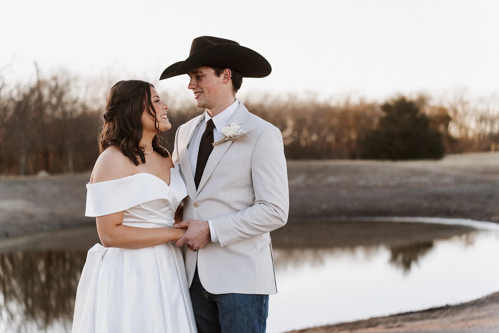 Sunset wedding portrait by the water at The County Line in Abbott, TX