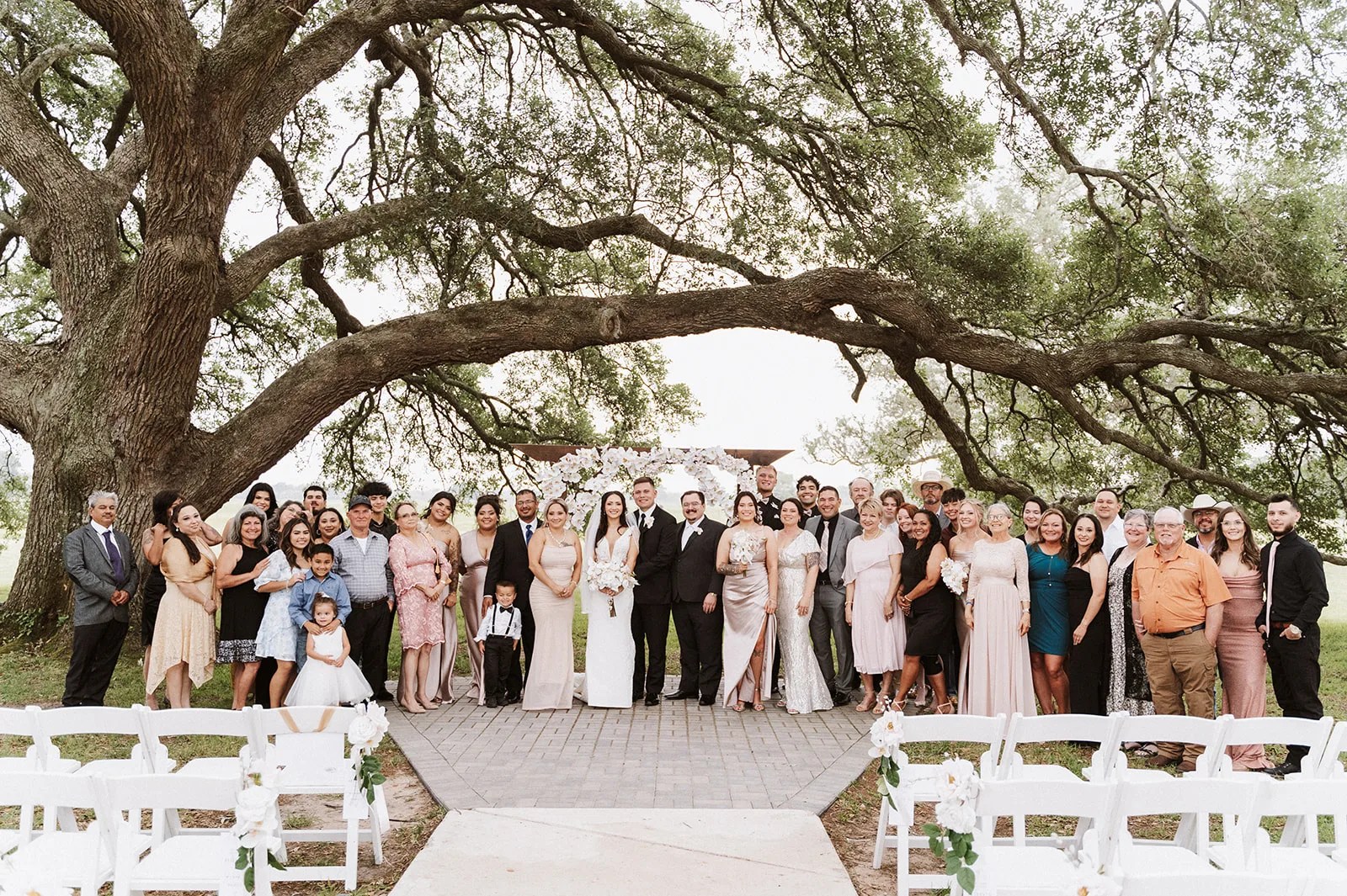 Wedding party under the oaks at The Evermore in Edna, TX