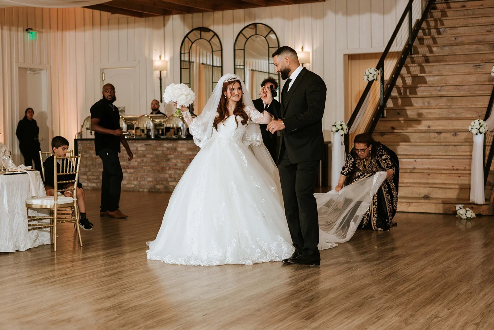 Bride on the grand staircase at The Milestone Georgetown in Georgetown, TX