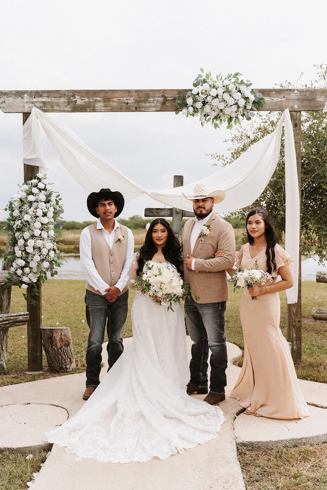 Wedding party at the ceremony arch at Tin Spur Ranch, Inez, TX
