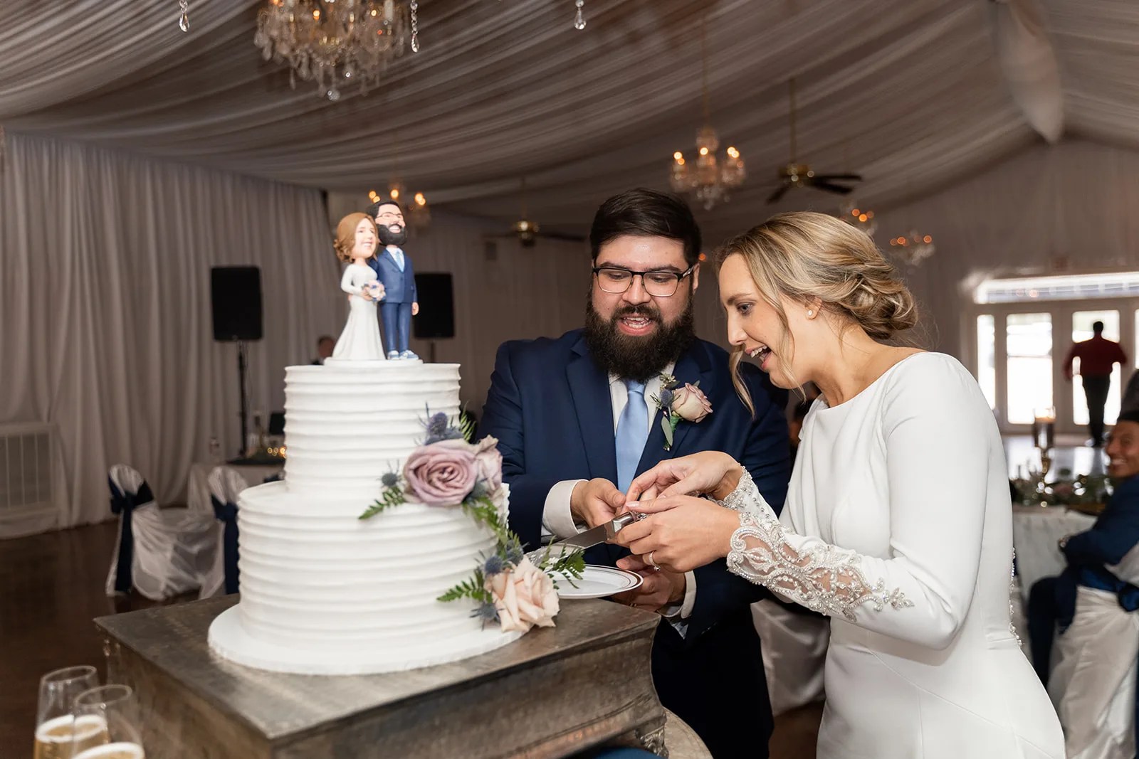 Cake cutting in the reception hall at Waverly Manor in New Waverly, TX