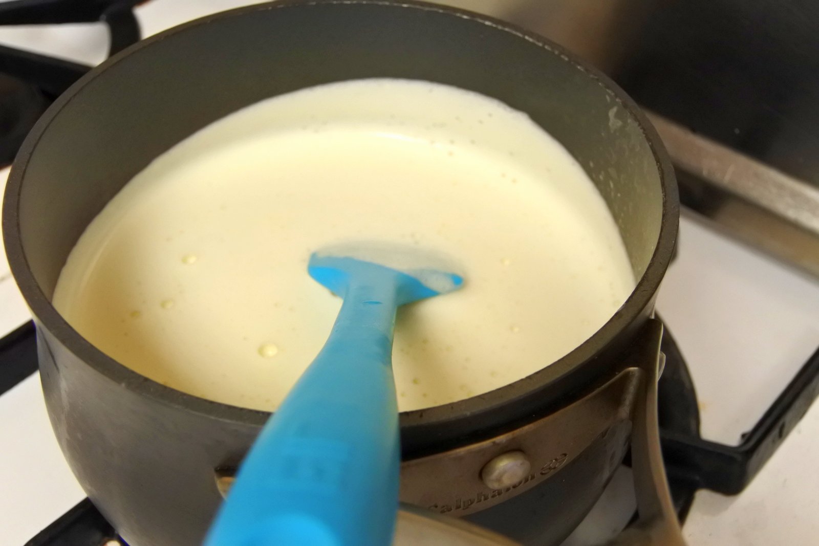 Add milk to yolk mixture (temper the eggs first), strain and heat over medium heat