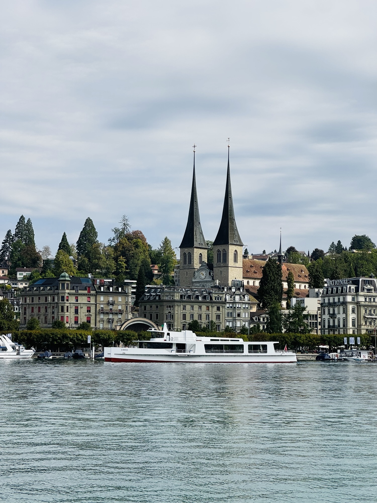 Large boat on river in Lucerne Switzerland with city buildings in the background