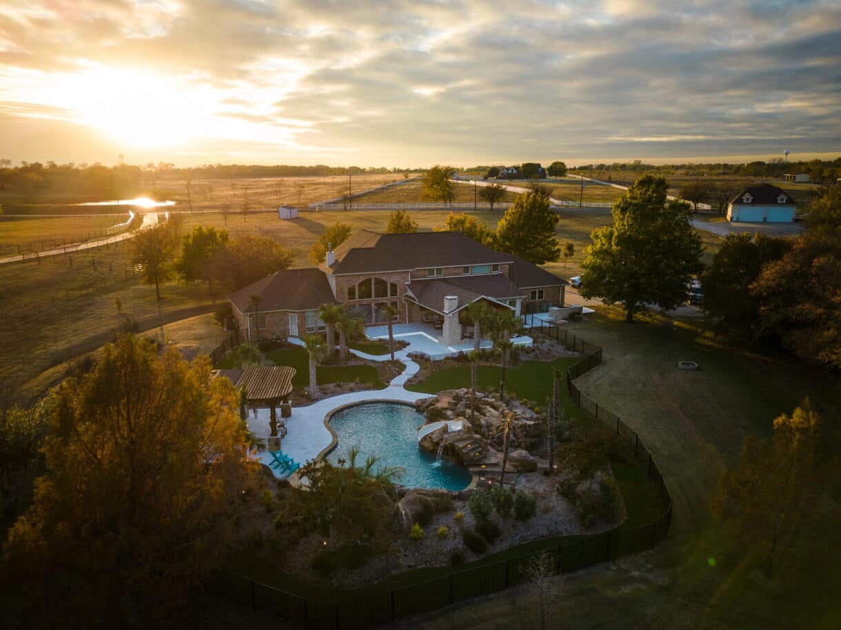 Weisz Selection Shade Structures, Landscape and Pools - aerial photo of a pool and patio at sunset