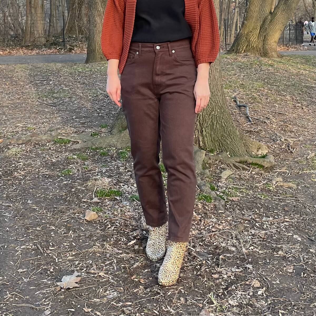 Everlane Cheeky Jean in brown, worn by a person with leopard print boots, from the front.