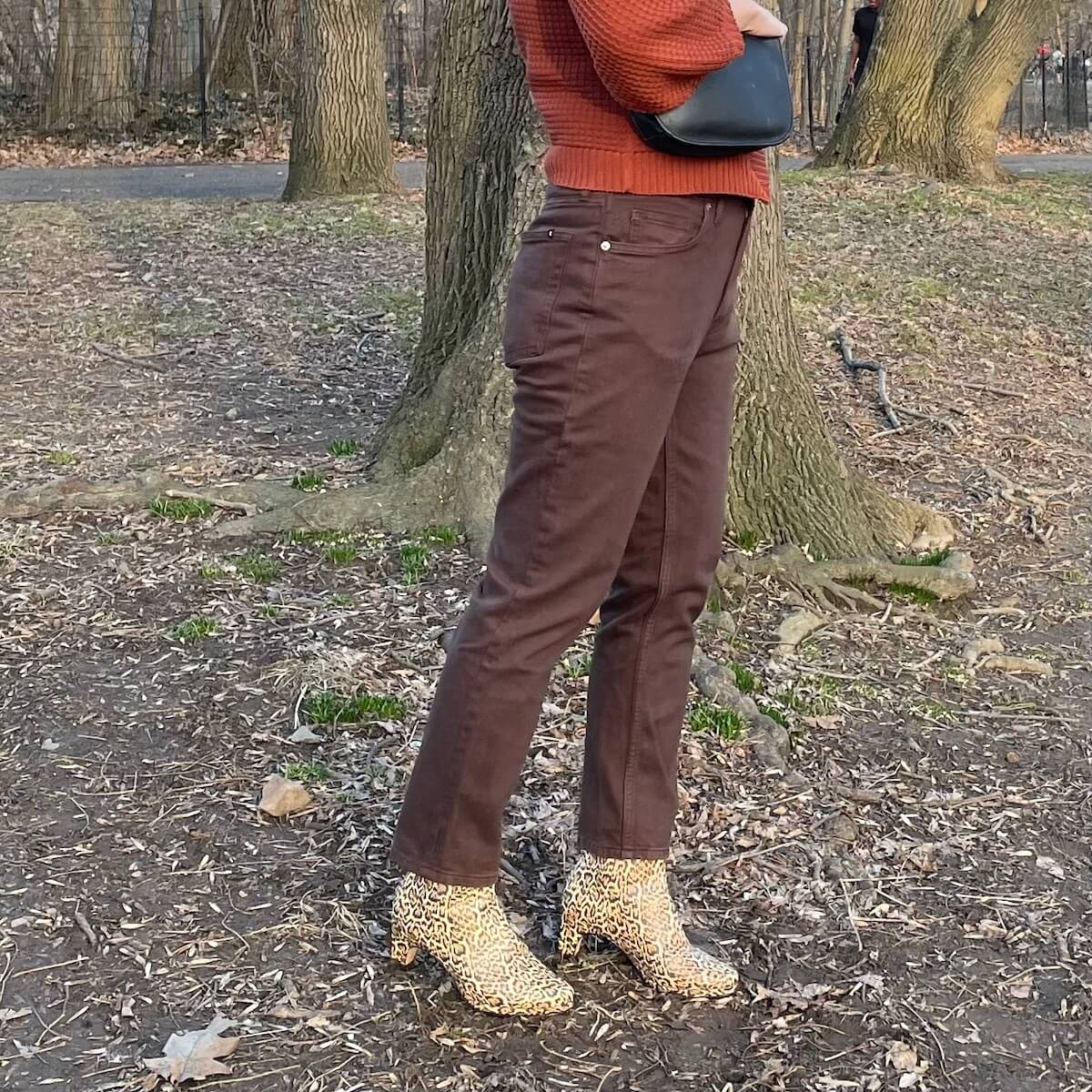 Everlane Cheeky Jean in brown, worn by a person with leopard print boots, from the side.