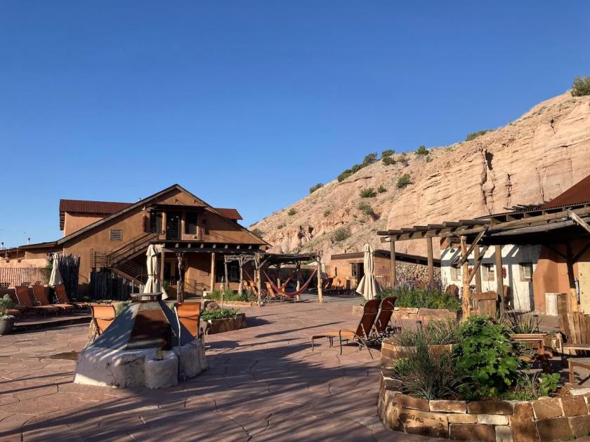 New Mexican cliffs overlook buildings at Ojo Caliente.