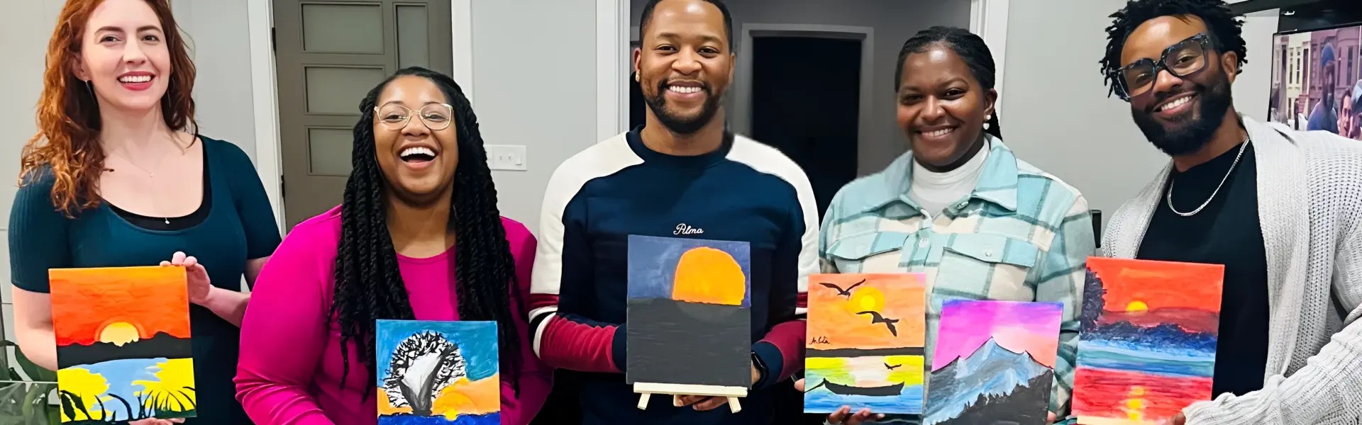 a group of individual having a photo holding the art they created