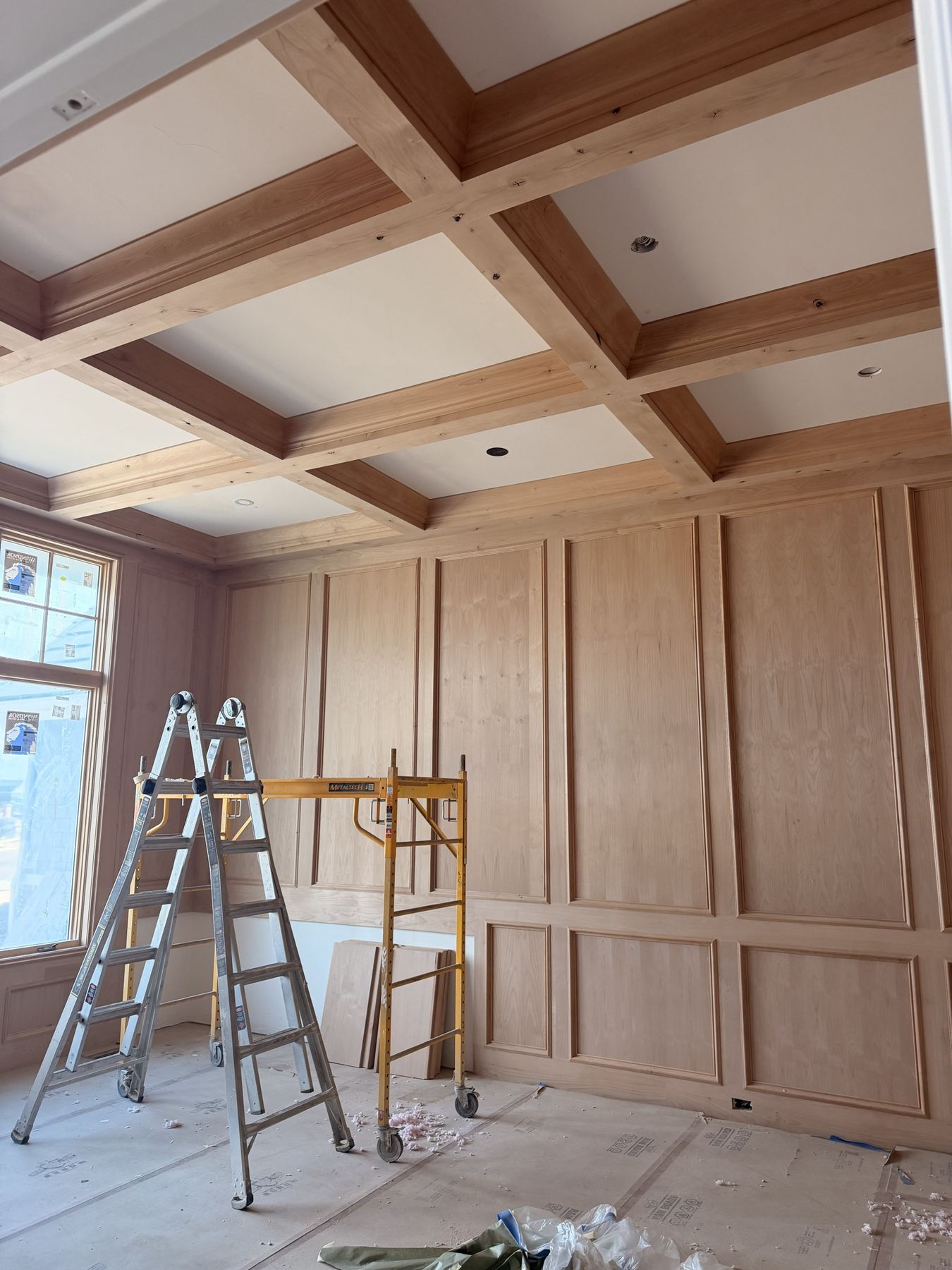 Coffered ceiling and raised-panel wood walls