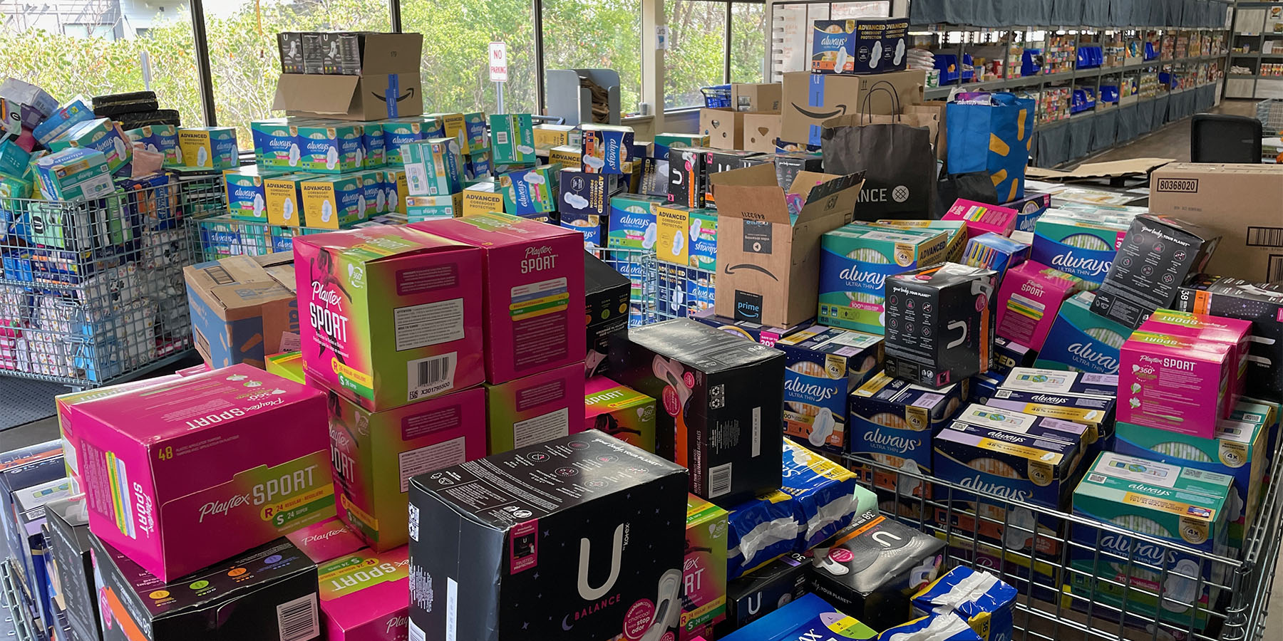 Piles of tampons and pads donated to a food shelf.