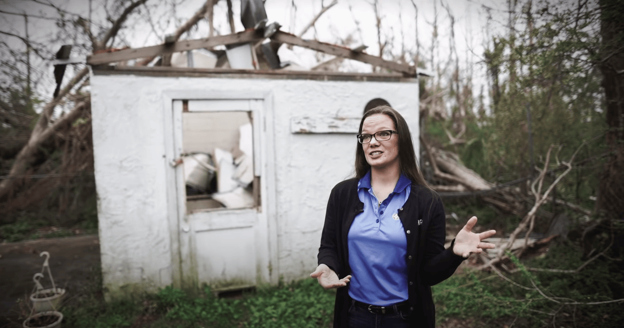 Wewa Films | Woman speaks in front of a building destroyed by Hurricane Michael