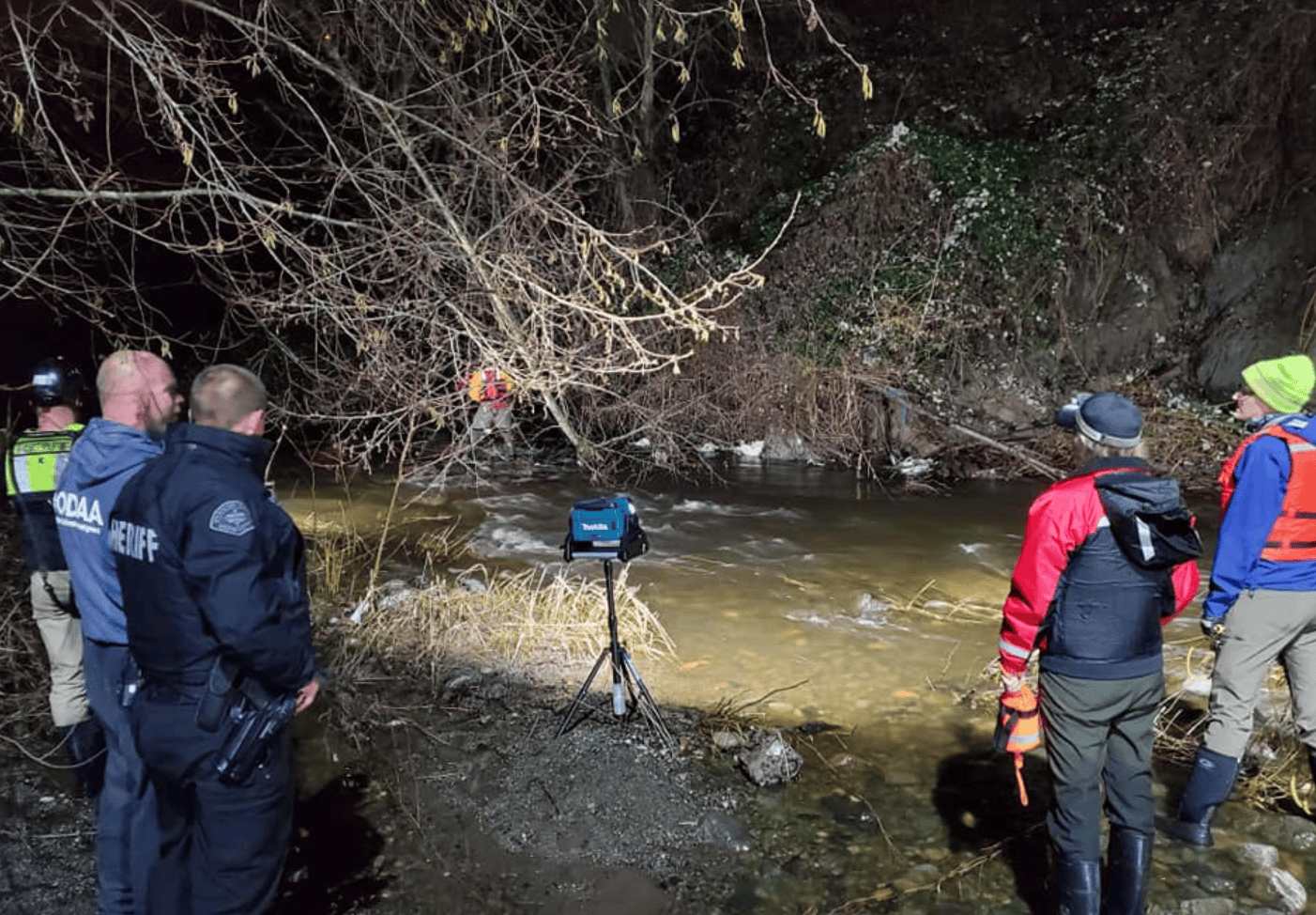 Volunteers with Whatcom County Search & Rescue and Summit to Sound Search & Rescue work with Bellingham Fire Department to recover a body found in Squalicum Creek (December 14, 2021). Photo: WCSAR