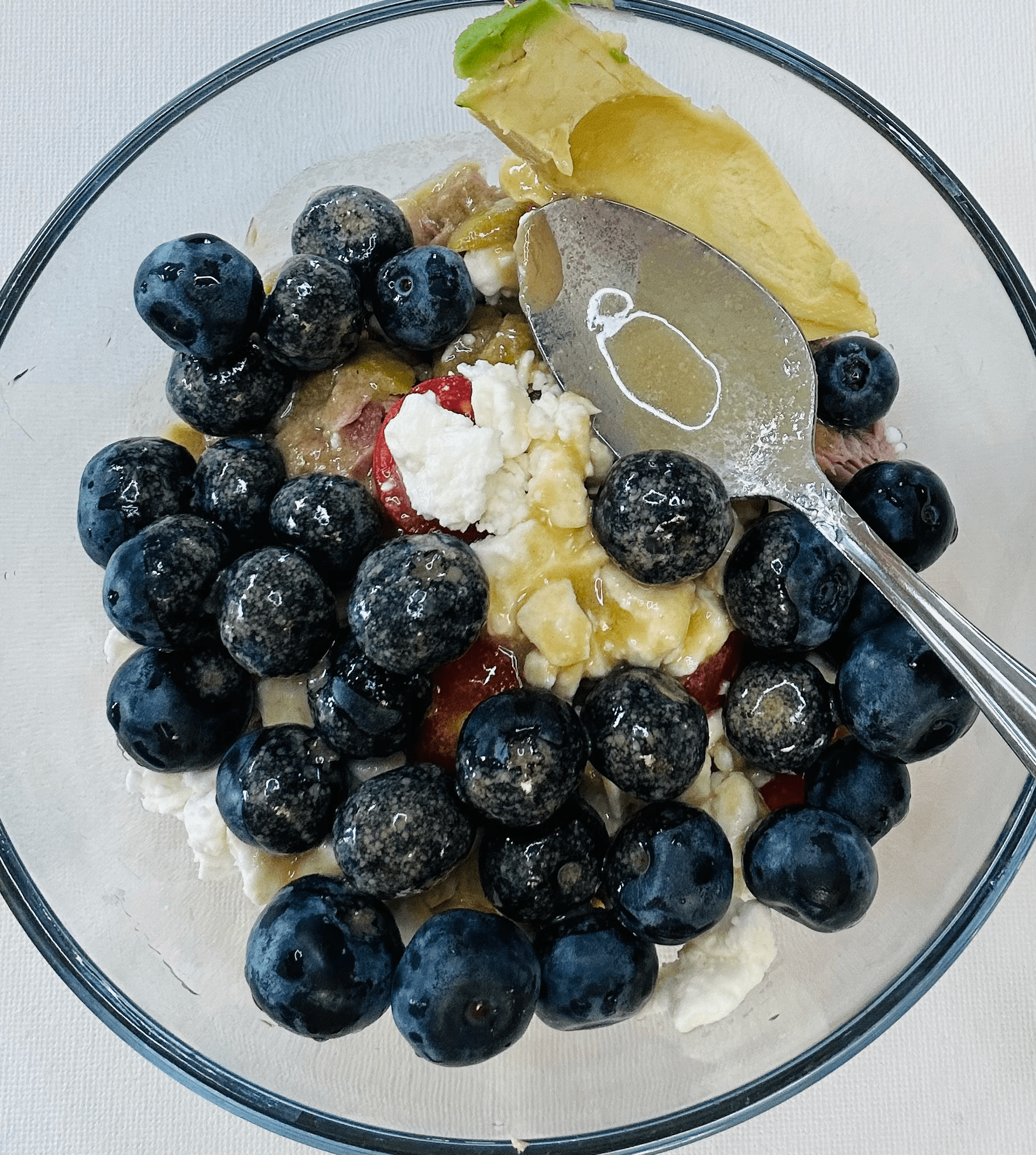 Chickpea blueberry tuna salad with avocado, feta, green olives and tomatoes topped with tahini dressing