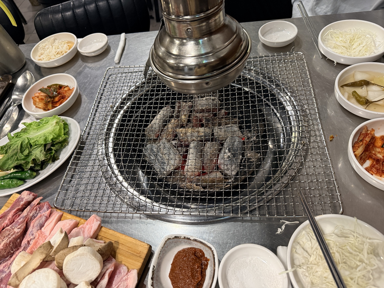 Charcoal grill with hangjeongsal, galmaegisal and Korean side dishes at Handoni Sindang