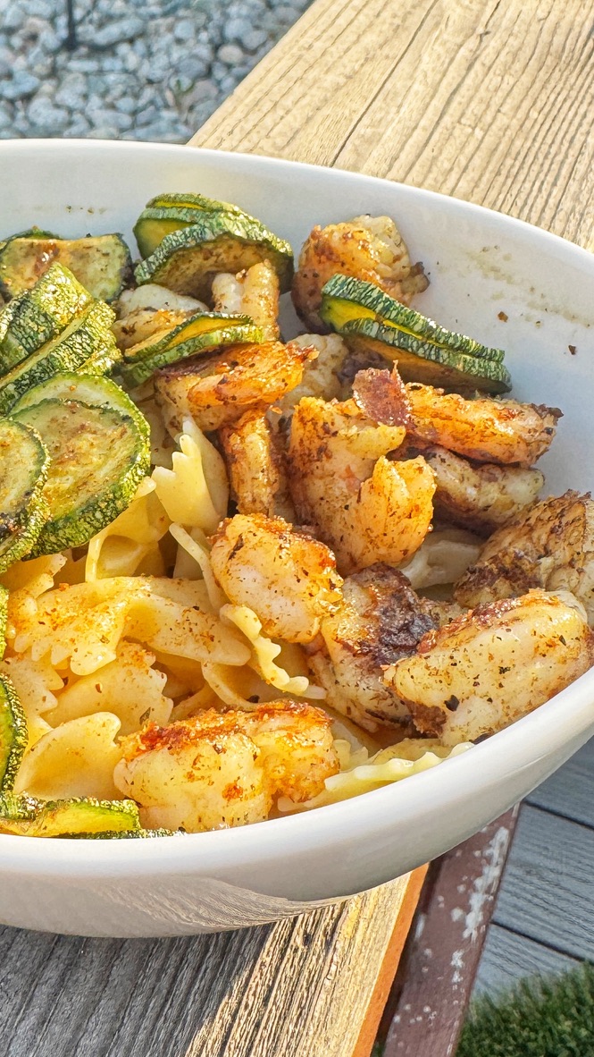 Creamy Garlic Parmesan Shrimp & Zucchini Pasta in a bowl with bowtie pasta, seared shrimp, and grilled zucchini