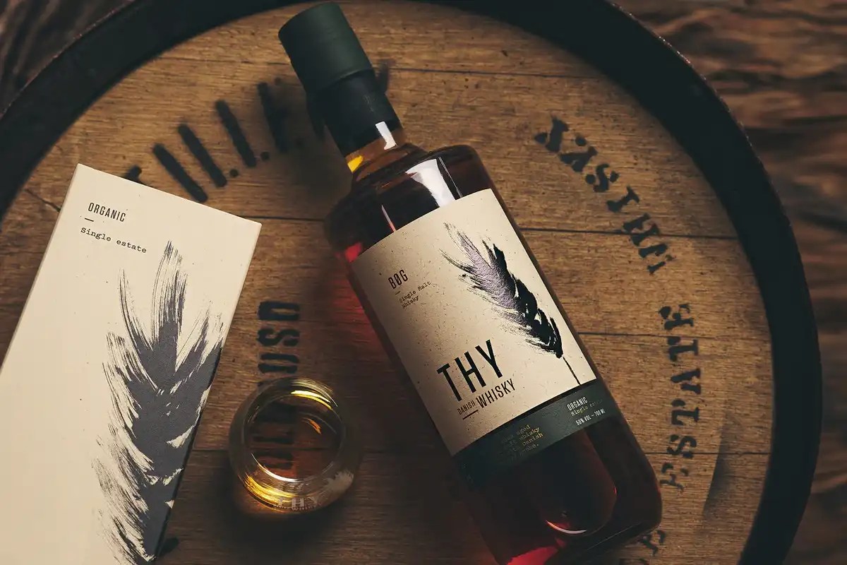 Thy Bøg Danich Whisky with a glass of whisky and gift box on a whisky barrel