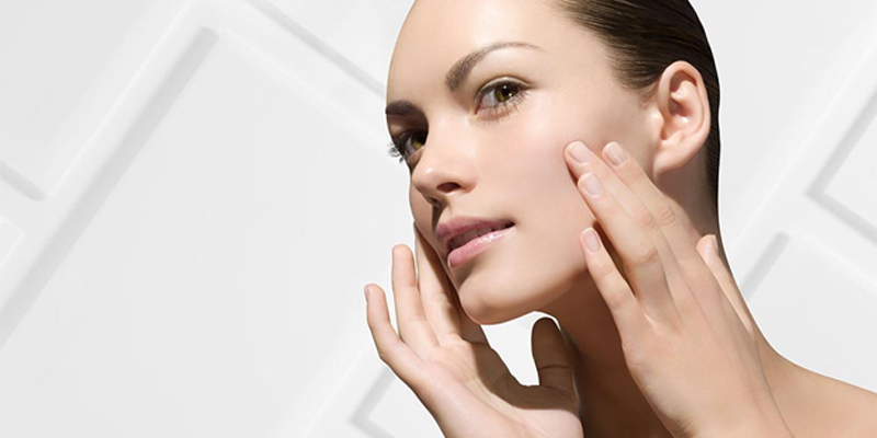 woman with her hands on her face, reflecting concern about common misconceptions regarding sensitive skin