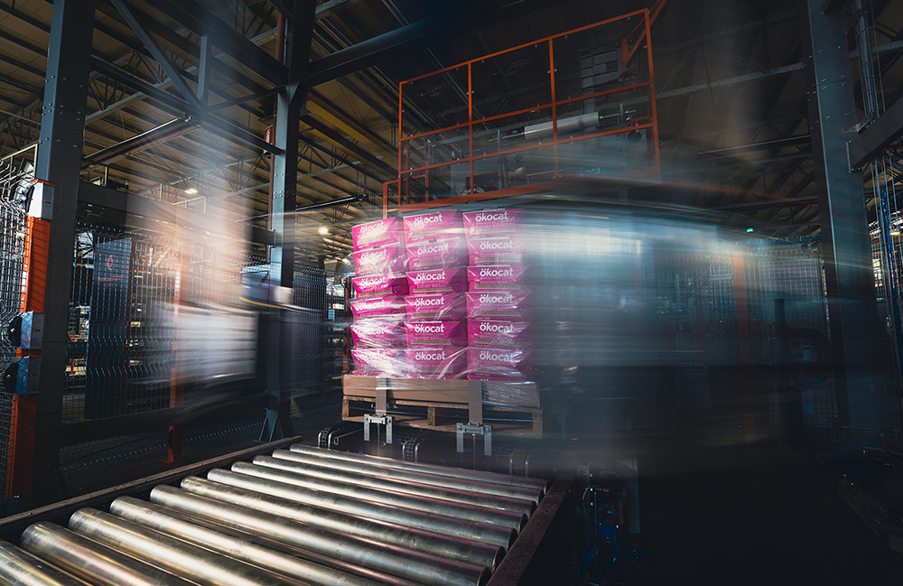 A full pallet moving along a conveyor belt as part of a packaging line.
