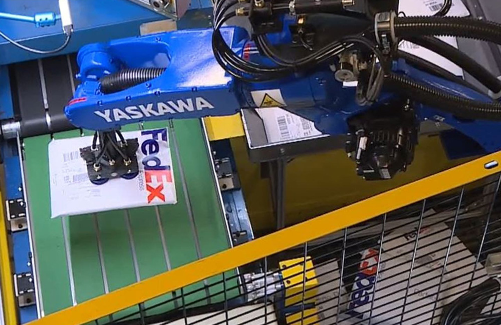 A Plus One Robotics-powered robotic arm working in a FedEx facility.