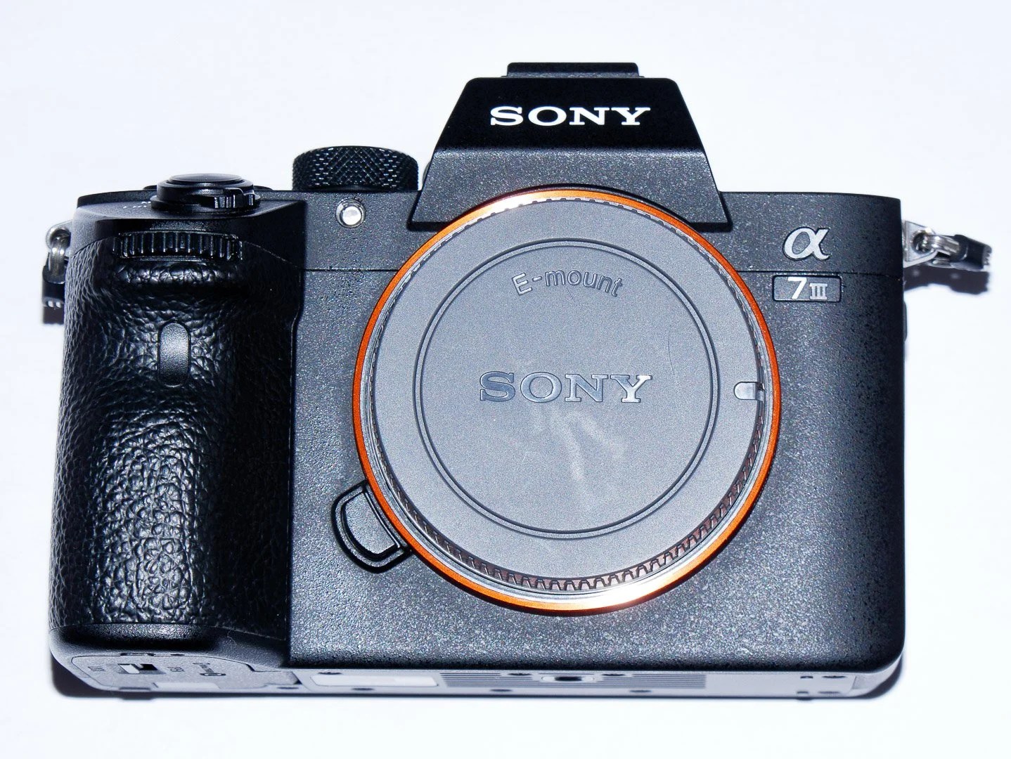 Sony α7 III seen from the front with its E-mount body cap attached.