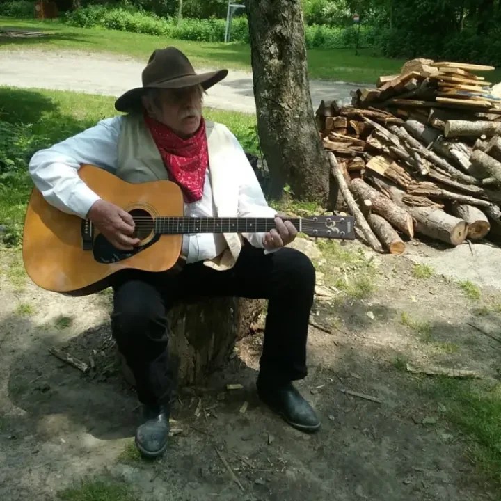 Rocky Mountain Ray strumming his guitar