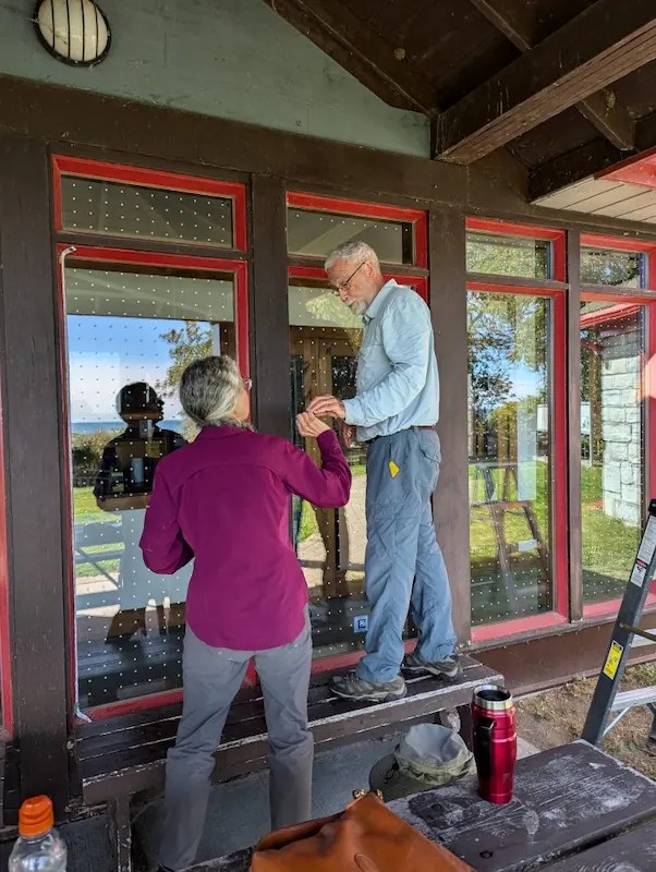 Club members installing bird safe window stickers at Presqu'ile Lighthouse Centre