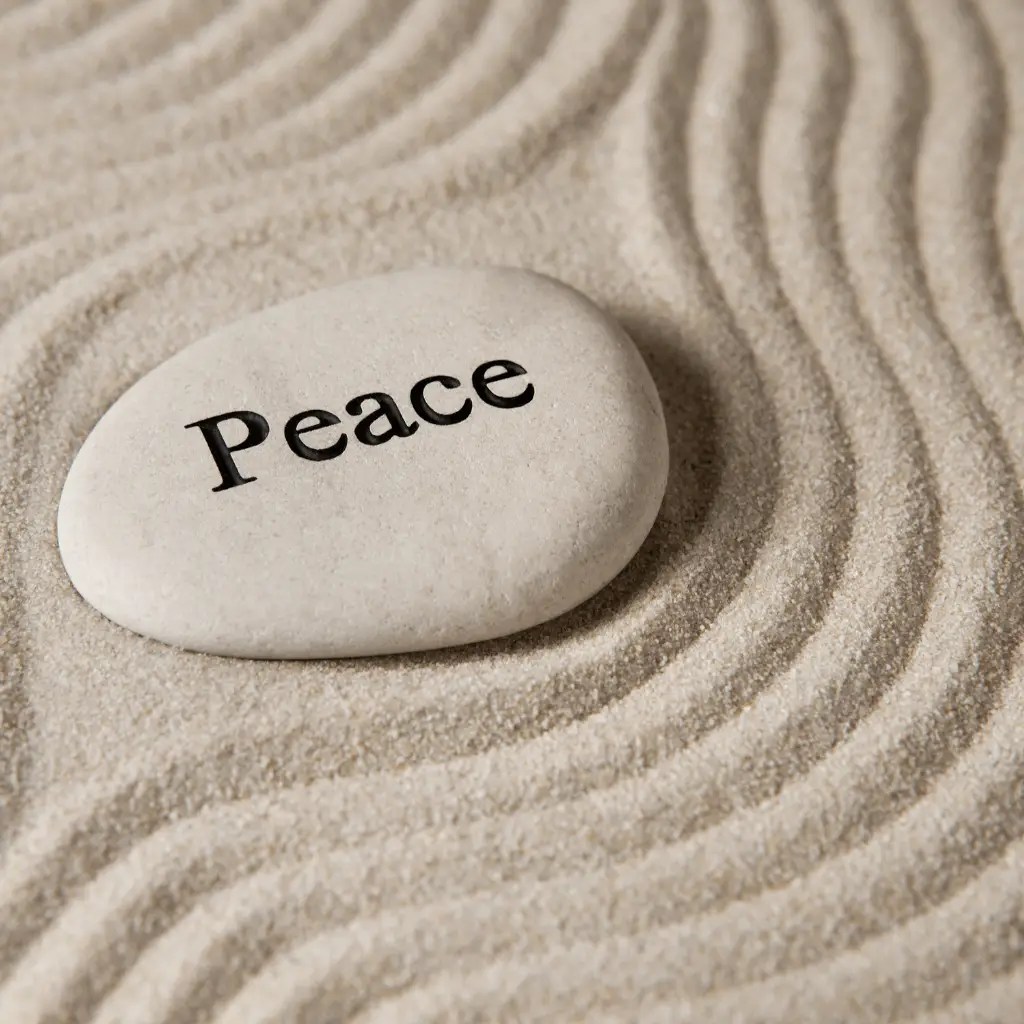 Smooth stone engraved with the word peace, representing calm and clarity through therapy for pornography addiction