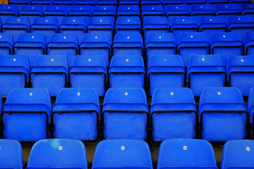 Repeating Rows of Blue Tip UP Stadium Seats empty at Deva Stadium, Home of Chester FC.