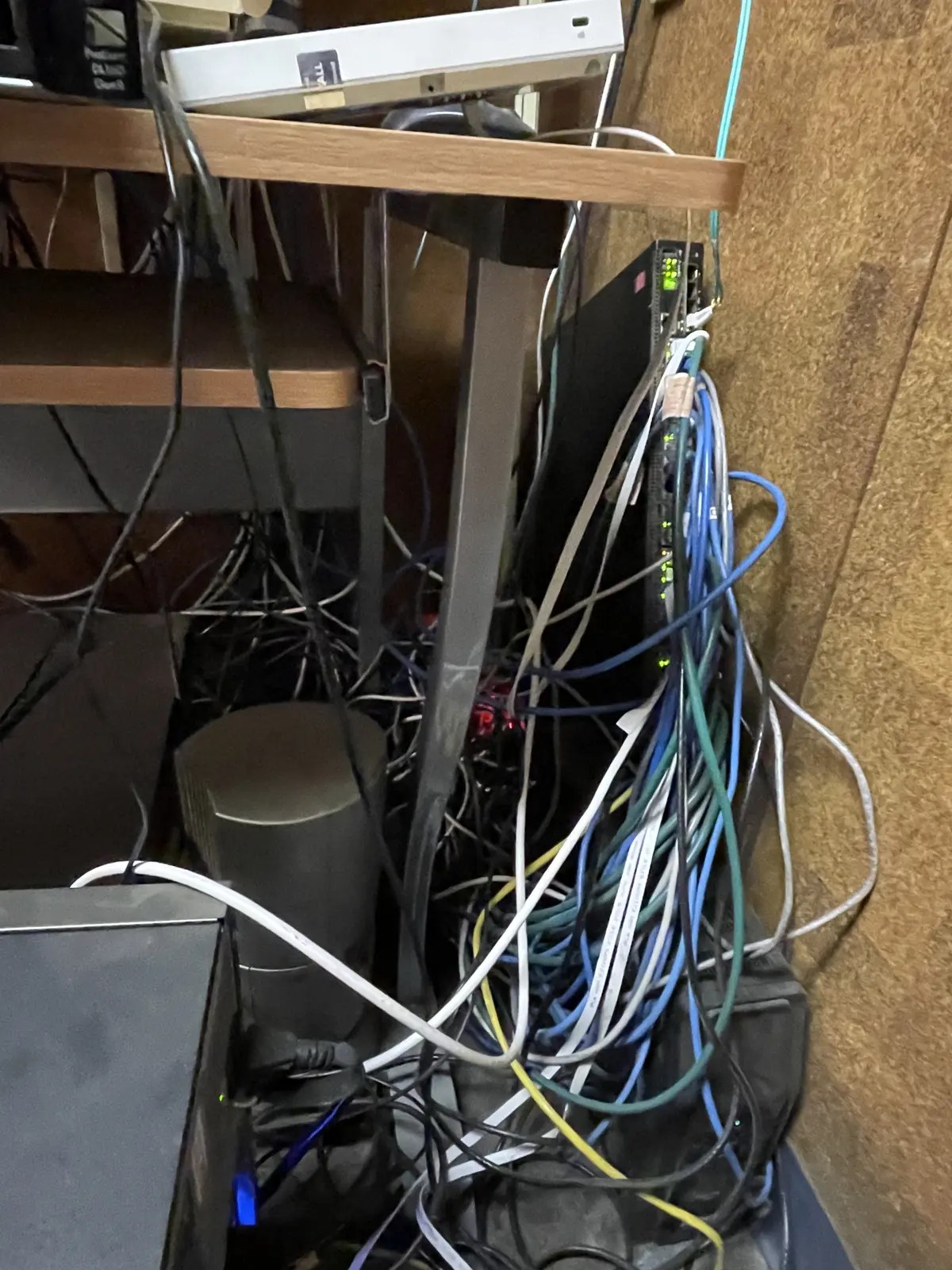 Tangled network cabling before professional cable-management cleanup.